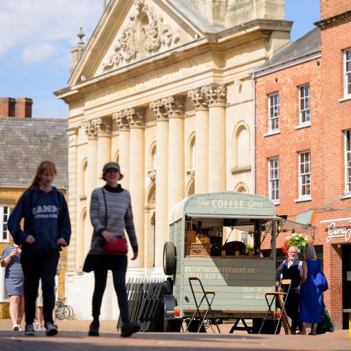 Image of buildings and individuals walking past in Cherwell