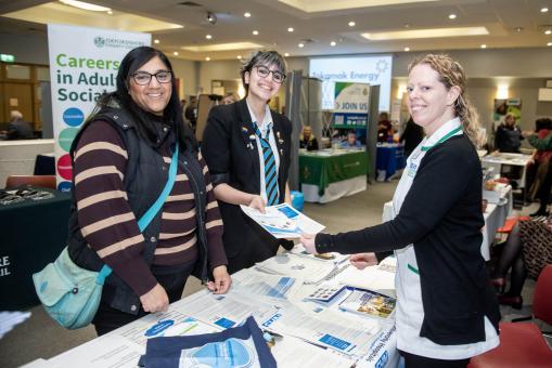 Image of business delegate and individuals attending Careers Fest congregating around a stand at the event