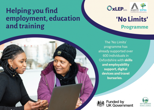 Image of individual seeking employability support, sat looking at laptop with other individual offering guidance